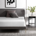 Weekender Jersey Mattress Protector by Malouf on a queen bed for waterproof, quiet protection.