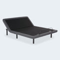 Perspective view of the iDealBed Smart 4i adjustable bed frame with the head section raised and charcoal grey upholstery detail.

