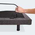 Detail of the tool-free mattress retainer bar being installed at the foot of the Malouf M455 adjustable power base.
