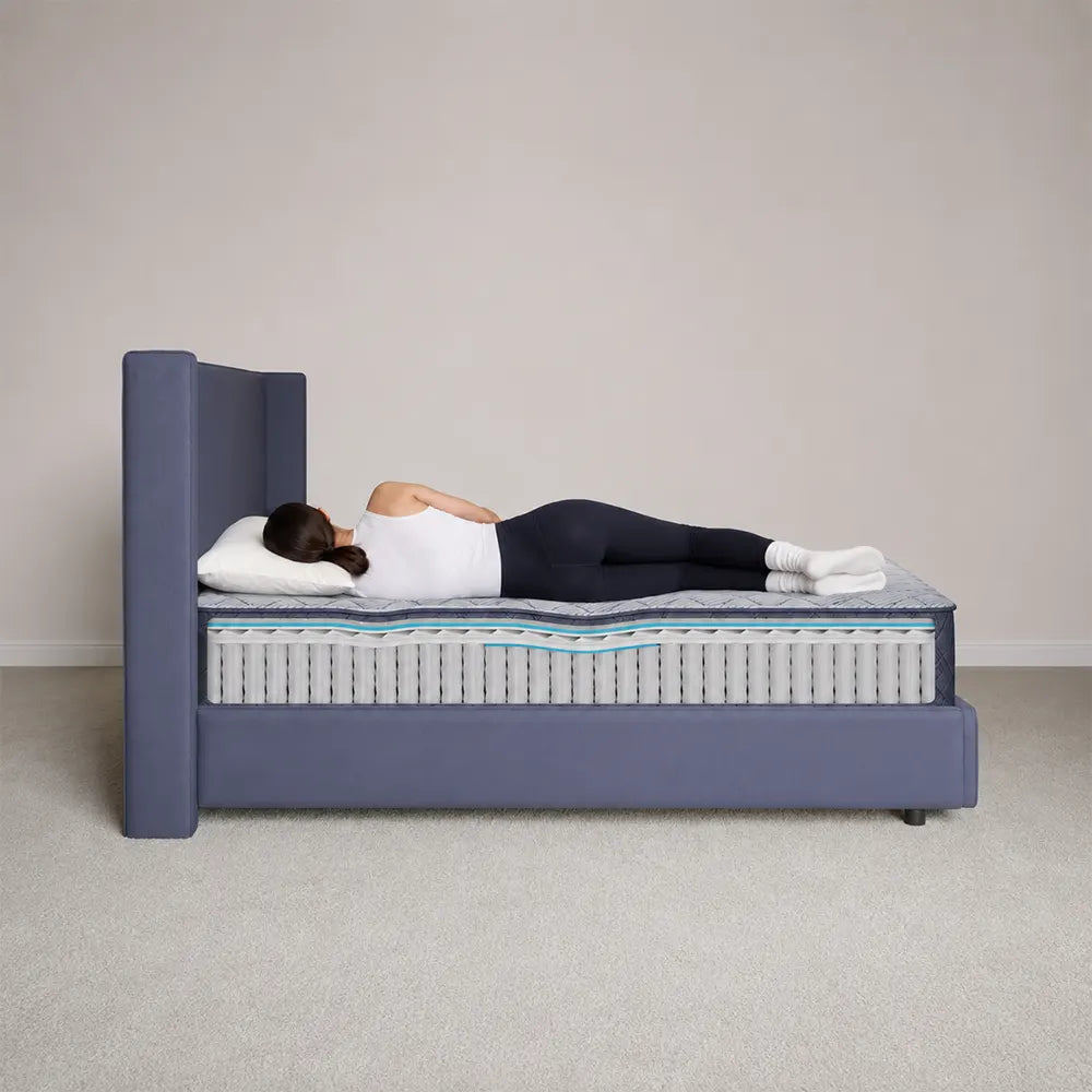 Person sleeping on their side to show proper alignment on the Serta Perfect Day 12 inch firm mattress.
