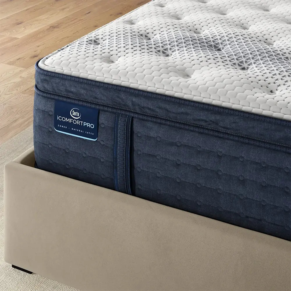 Serta iComfortPRO Buckingham mattress corner showing the thick latex foam pillow top construction.
