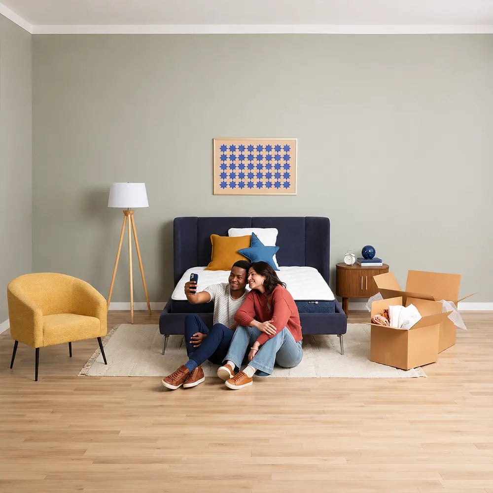 Happy couple unboxing their new Serta Perfect Day 8 inch Medium Mattress in a Box in their bedroom.
