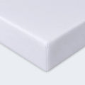 Detailed corner view of a white moisture-wicking Hyper-Wool fitted crib sheet by BEDGEAR.
