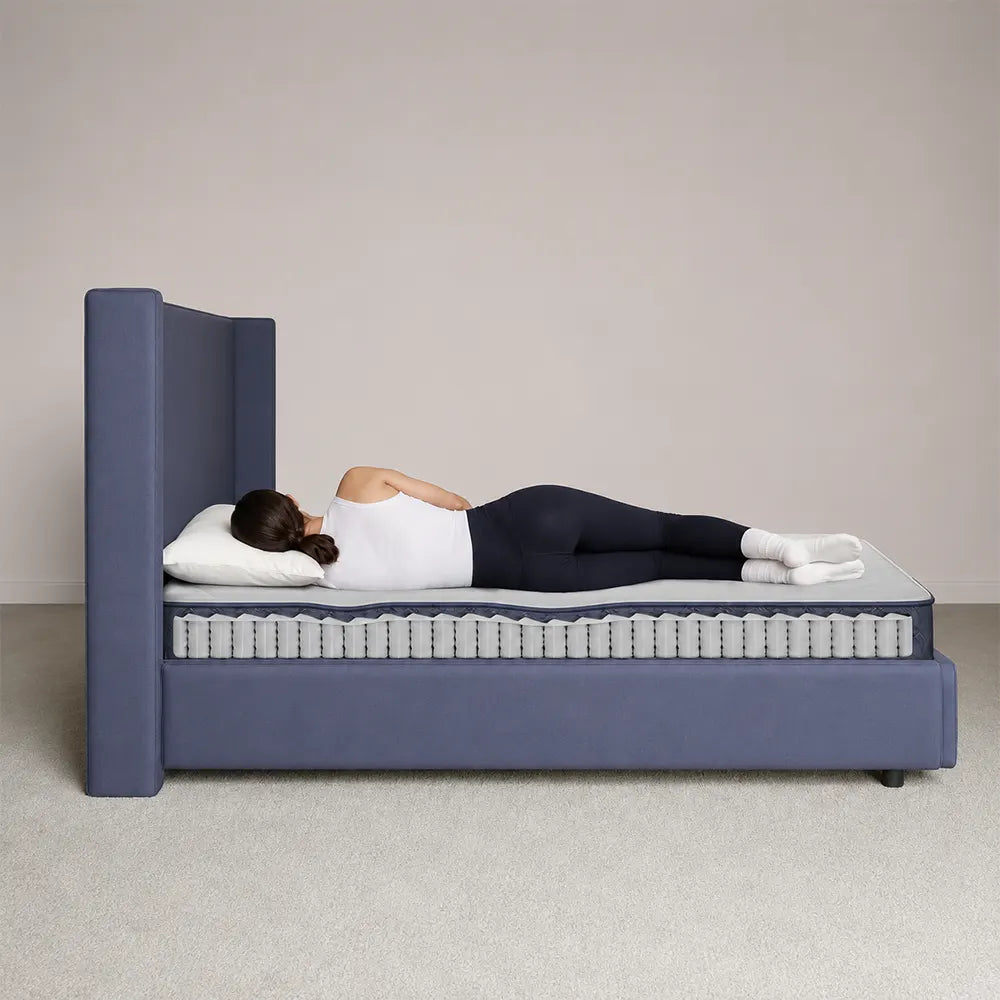 Side sleeper demonstration showing spinal alignment on the Serta Perfect Day firm pocketed coil mattress.
