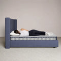 Side sleeper demonstration showing spinal alignment on the Serta Perfect Day firm pocketed coil mattress.
