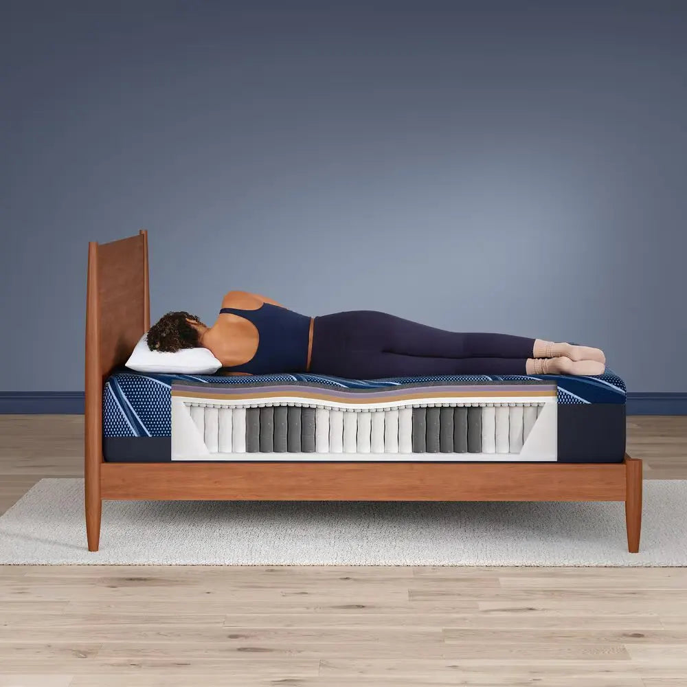 Side sleeper on Serta iSeries NXG 3500 firm hybrid mattress showing spinal alignment and support.
