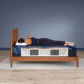 Side sleeper on Serta iSeries NXG 3500 firm hybrid mattress showing spinal alignment and support.
