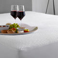 SleepTone SmartGuard mattress protector with IceTone cooling fabric, stain-resistant against red wine spills.
