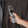 Close-up of the silver wireless remote for the Malouf M555 adjustable base with buttons for massage and Zero Gravity.

