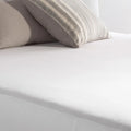 Close-up of the smooth, breathable surface of a Weekender by Malouf mattress encasement.
