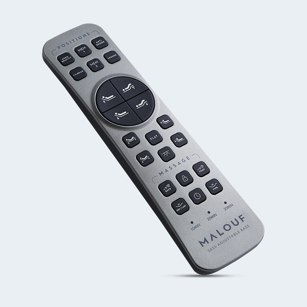 High-tech silver wireless remote for the Malouf S655 adjustable base featuring dedicated buttons for pillow tilt, massage, and Zero Gravity.
