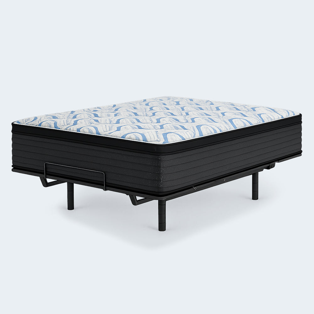 14-inch Ashley Elite Springs plush mattress on an adjustable bed frame highlighting the blue wave pattern on the quilted cover.
