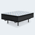 14-inch Ashley Elite Springs plush mattress on an adjustable bed frame highlighting the blue wave pattern on the quilted cover.