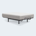 Terra Sleep 12-inch firm mattress by Ashley displayed on a modern adjustable bed frame with mattress retainer bars.