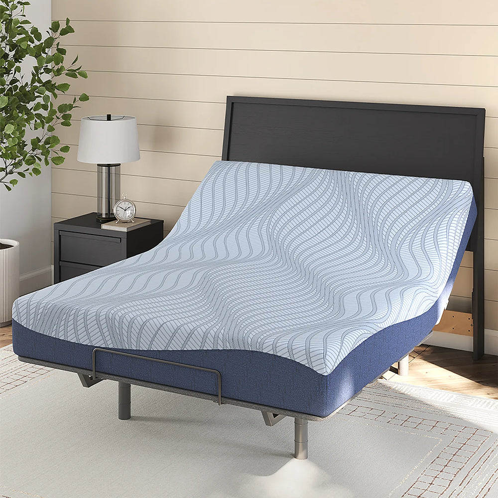 Ashley Peak 2.0 10-inch memory foam mattress with the head section elevated on an adjustable power base in a bright, modern bedroom.
