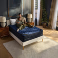 Couple lying together on a DreamCloud Ultra 15-inch mattress, illustrating ergonomic support for back and side sleepers on a medium-firm hybrid.
