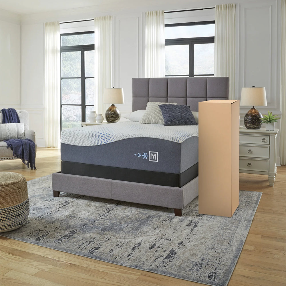 The Millennium Luxury Gel Memory Foam Mattress styled in a master bedroom with its shipping box, demonstrating the convenient unboxing process.
