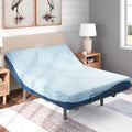 Ashley Peak 2.0 memory foam mattress with the head section elevated on an adjustable power base in a bright coastal-style bedroom.
