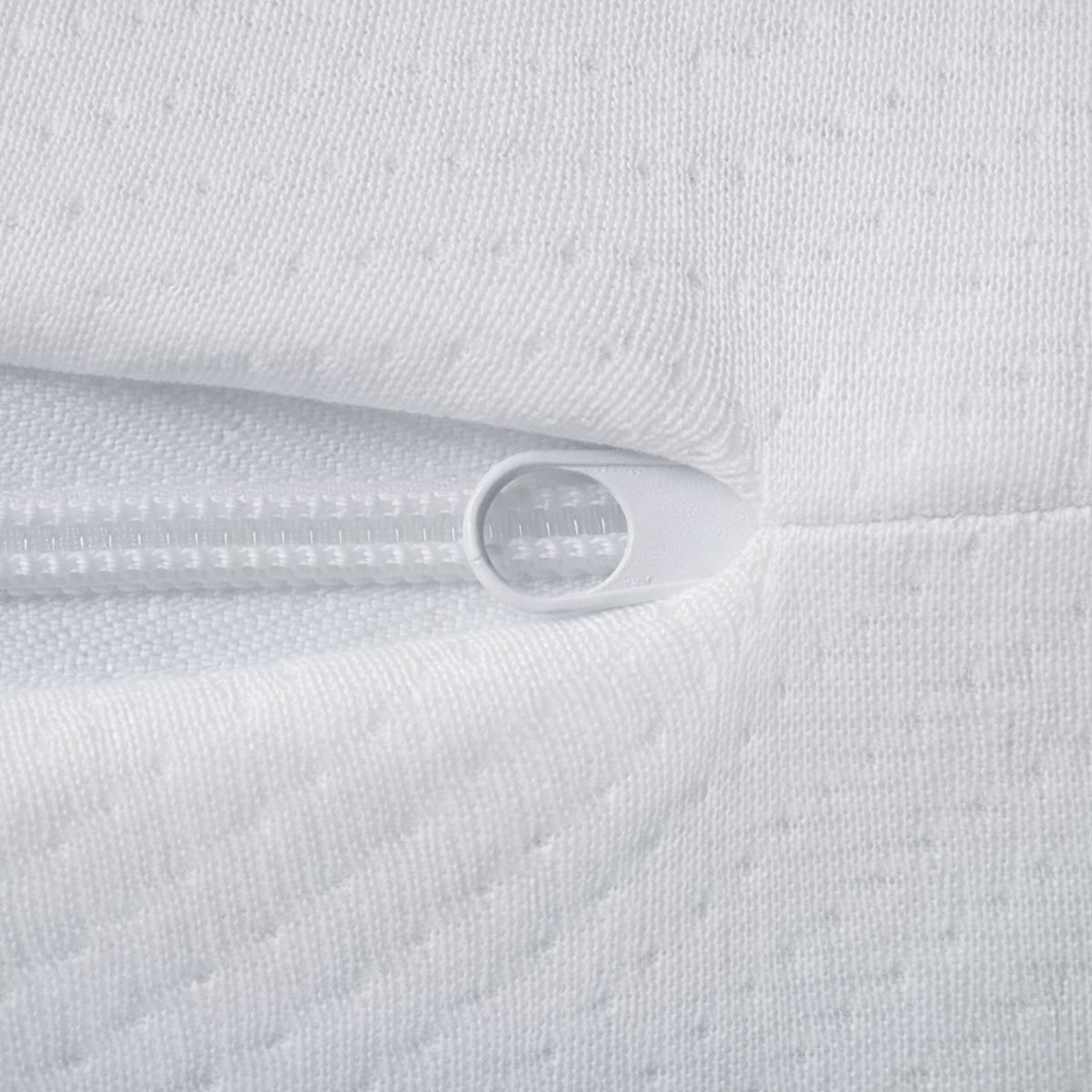 Close-up of the secure white zipper on the removable cover of the Organic Hybrid Crib Mattress.