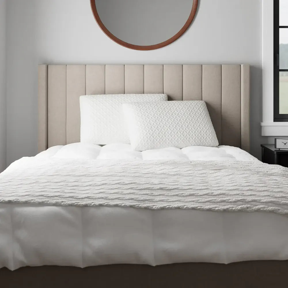 Malouf HyperChill pillow protectors on a bed providing a clean, temperature-regulated sleep.
