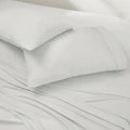 Two crisp white Ver-Tex pillowcases on matching cooling luxury sheets by BEDGEAR.
