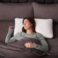 Woman sleeping on a Malouf FlexFill pillow designed for proper neck alignment and cool back support.
