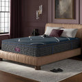 Side view of the Beautyrest World Class Hybrid Medium Pillow Top Mattress in a designer bedroom.
