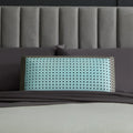 Luxury Malouf CarbonCool cooling pillow on a bed, designed for ergonomic head and neck alignment.
