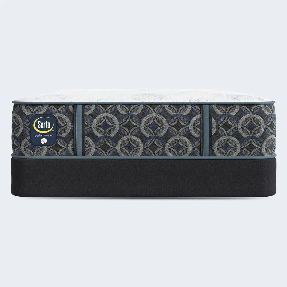 Serta Cascade Bluff Hybrid Firm mattress on a supportive black foundation for a durable sleep surface.
