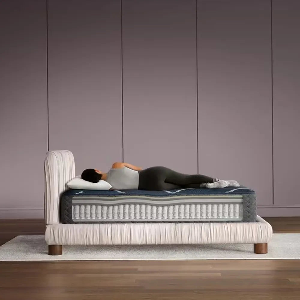 Spine alignment demonstration on a Beautyrest World Class 13.5" mattress for restorative, healthy sleep.
