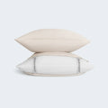 Stacked pillows with beige BEDGEAR Hyper-Linen cases, offering a plush linen-blend feel and cooling benefits.
