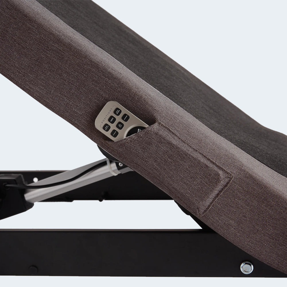 Detail shot of the built-in remote storage pocket on the upholstered side of the Malouf M555 adjustable bed base.
