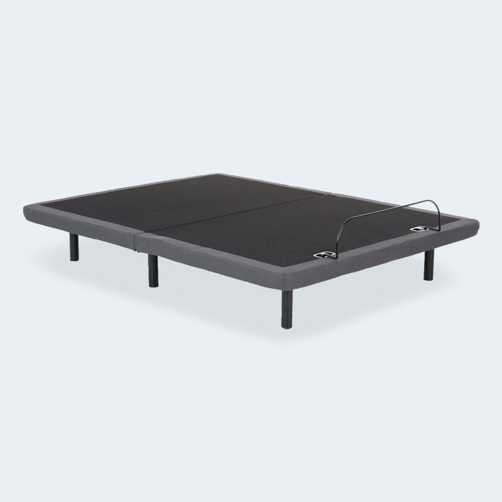 High-angle perspective of the iDealBed Smart 4i custom adjustable bed base in a flat position showing the upholstered deck.
