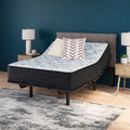 Ergonomic bedroom setup with the Elite Springs 14-inch firm mattress by Ashley elevated on an adjustable base for personalized comfort.

