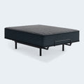 Side view of the Ashley Gray 1200 Hybrid firm mattress on a black metal adjustable power base with a mattress retainer bar.
