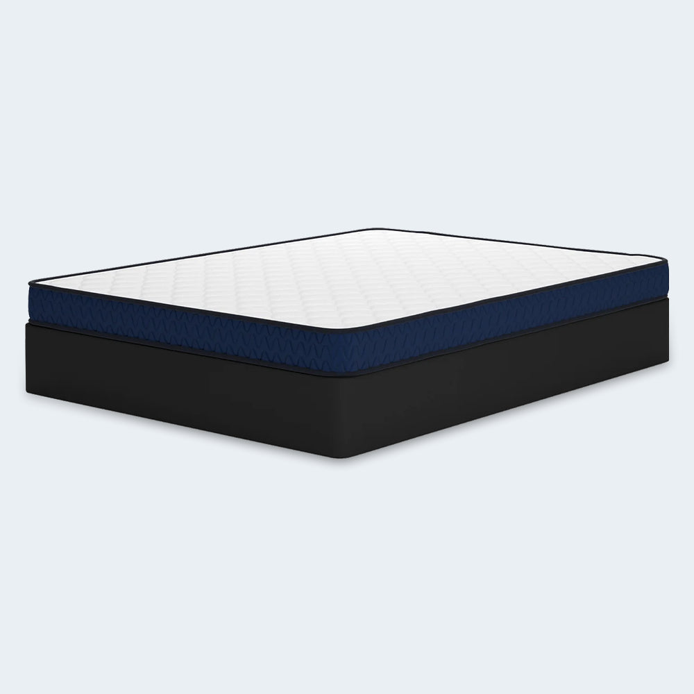 Side perspective of the 6-inch firm mattress by Ashley Sleep featuring navy blue side panels and a slim, low-profile design for bunk beds or guest rooms.
