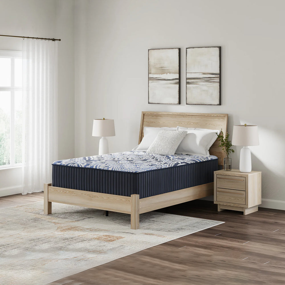 Luxe 2.0 Blue 15-inch Mattress by Ashley Sleep styled in a contemporary bedroom with a light wood bed frame and neutral decor.
