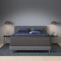 Modern bedroom featuring a Tommie Copper Core Znergy plush hybrid mattress on a grey tufted frame with copper pendant lights.

