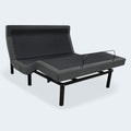 Three-quarter view of the iDealBed Smart 6i adjustable bed frame in a full sitting position with a mattress retainer bar.
