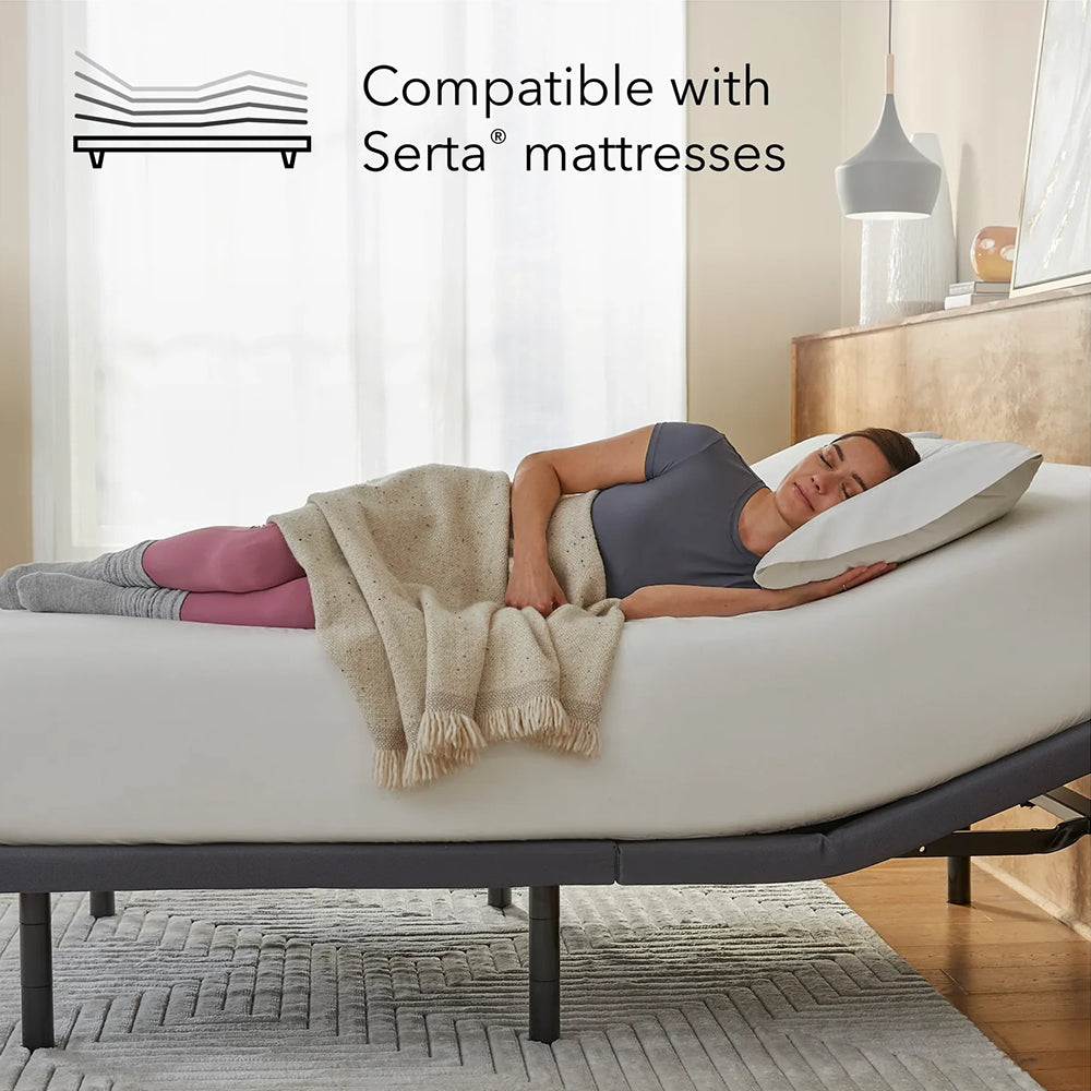 Woman sleeping comfortably on the Baselogic Gold adjustable base, highlighting its compatibility with Serta mattresses.
