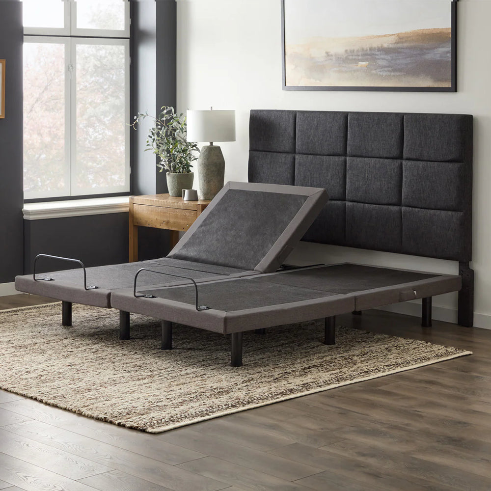 Malouf M455 split king adjustable bed showing independent side control with one head section elevated while the other is flat.
