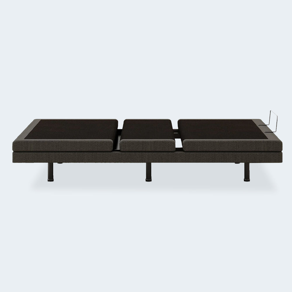 Side profile of the Comfort Ultra Adjustable Base by Ashley in its neutral flat position showing the heavy-duty low-profile frame.

