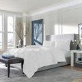 Elegant white SleepTone Tranquility pinch pleat comforter set for a clean, hotel-luxury bedroom look.
