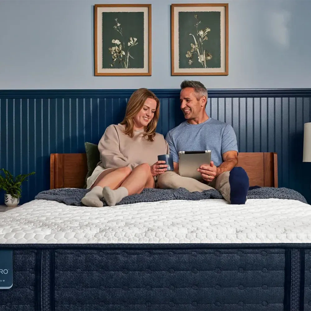 Couple relaxing on a Serta iComfortPRO Granby extra firm mattress, ideal for shared cooling and support.
