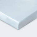 Close-up of a light blue Dri-Tec performance crib sheet corner highlighting the cooling fabric.
