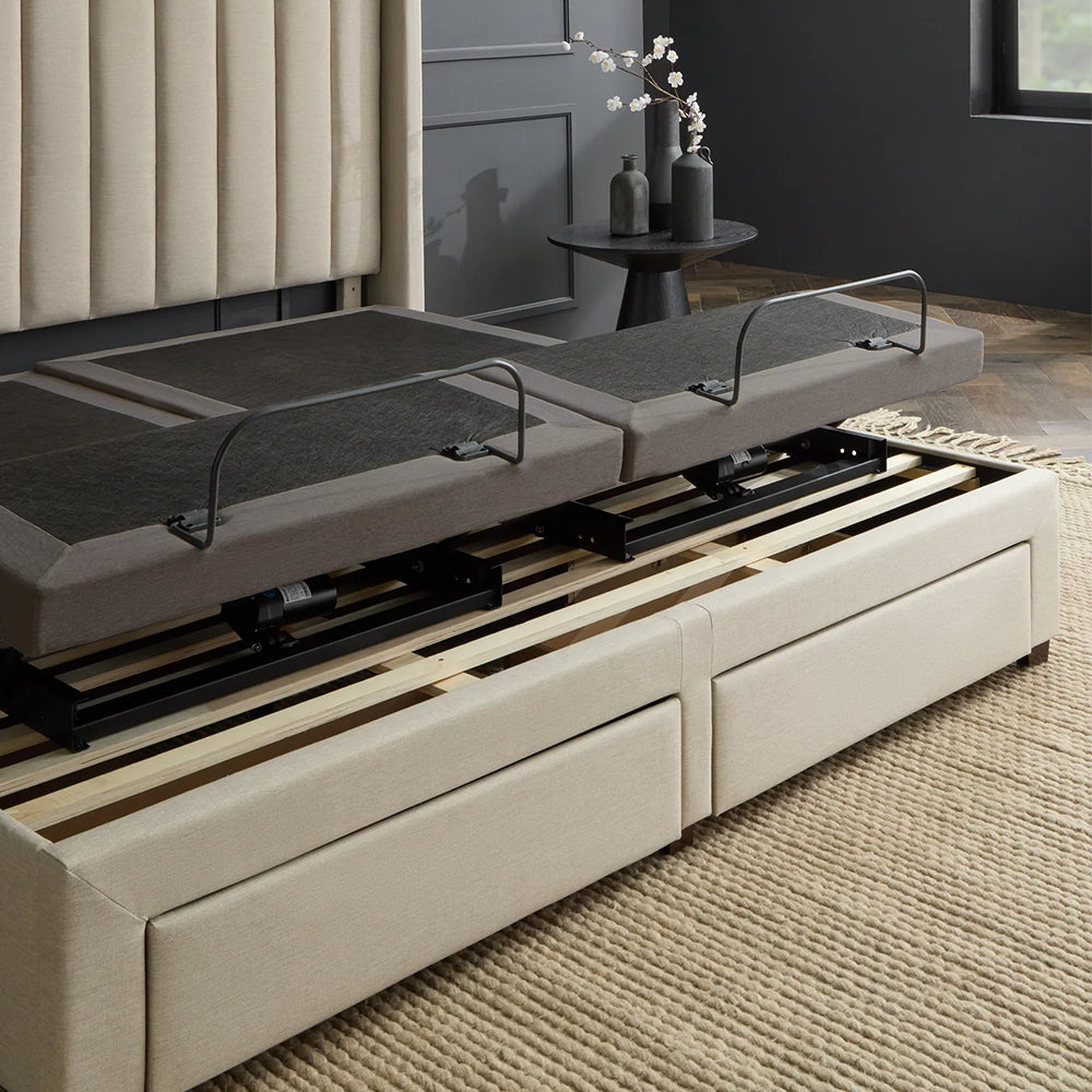 Close-up showing the Malouf S655 adjustable base's zero-clearance compatibility sitting directly on top of platform bed slats above storage drawers.
