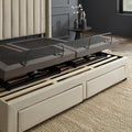 Close-up showing the Malouf S655 adjustable base's zero-clearance compatibility sitting directly on top of platform bed slats above storage drawers.
