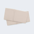 Folded beige BEDGEAR Hyper-Wool pillowcase set featuring natural temperature regulation and soft texture.
