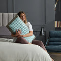 Woman hugging a plush Malouf CarbonCool LT pillow to demonstrate its soft, temperature-regulating comfort.
