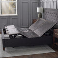 Malouf E455 adjustable base articulated within a charcoal fluted upholstered bed frame in a contemporary room.
